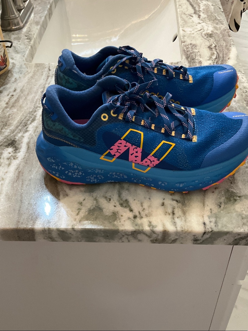 New Balance Blue Running Shoes with Pink Insole and Yellow Accents